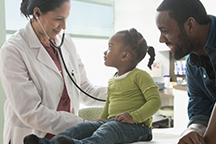 Female doctor with girl and father